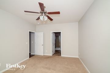 Moody house for rent - a living room with a ceiling fan and a carpet