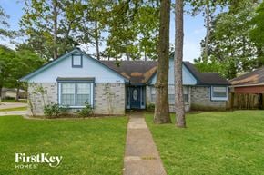 Spring house for rent - a blue and white house with a yard and trees