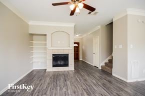 Spring house for rent - A spacious living room with a fireplace and a ceiling fan.