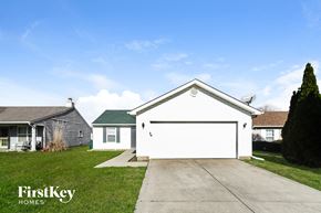 Indianapolis house for rent - a white garage door in front of a white house