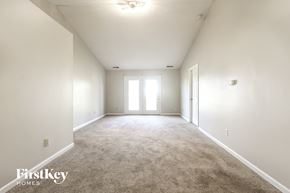 Indianapolis house for rent - an empty living room with white walls and carpet