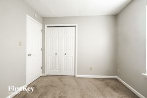 Indianapolis house for rent - a bedroom with two doors and a carpeted floor