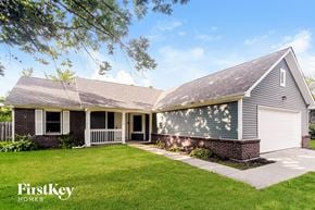 Indianapolis house for rent - A house with a garage and a well-kept lawn.