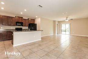 Wimauma house for rent - A spacious kitchen with a tiled floor and a large island in the middle.