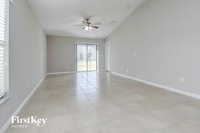 Wimauma house for rent - A spacious room with a ceiling fan and tiled flooring.