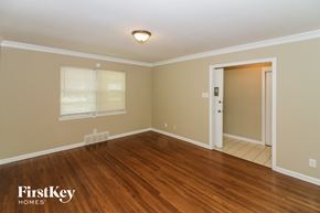 Memphis house for rent - A room with wooden floors and a door leading to another room.