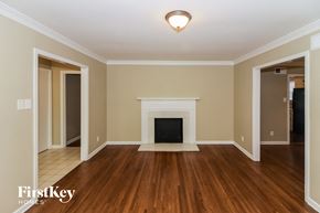 Memphis house for rent - A living room with a fireplace and wood floors.
