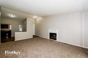Indianapolis house for rent - A living room with a fireplace and a carpet.