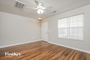 Winston-Salem house for rent - the spacious living room with wood flooring and a ceiling fan