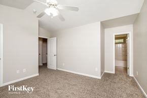 Winston-Salem house for rent - a master bedroom with carpet and a ceiling fan