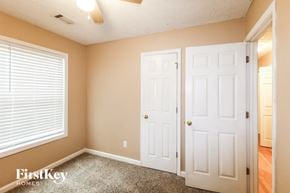 Flowery Branch house for rent - a bedroom with two closets and a window and a door