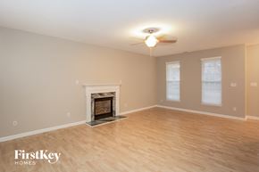 Concord house for rent - the living room with wood floors and a fireplace