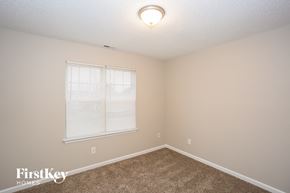 Concord house for rent - a bedroom with a large window and a carpeted floor