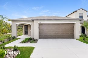 Wimauma house for rent - a home with a garage door and a driveway