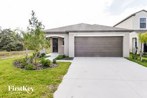 Wimauma house for rent - a house with a driveway and a garage door