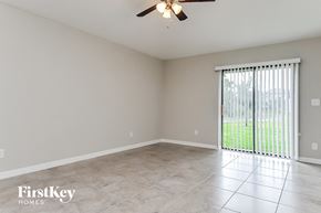 Wimauma house for rent - a living room with a large window and a ceiling fan