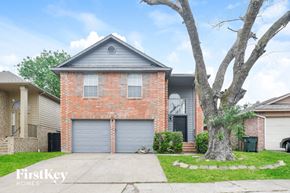 Garland house for rent - A brick house with a grey roof and a tree in front.