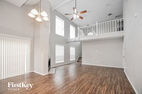 Garland house for rent - A spacious room with wooden floors and a balcony.
