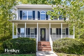 Winston-Salem house for rent - A white house with a porch and a brick staircase leading to the front door.
