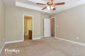 Winston-Salem house for rent - A spacious room with a ceiling fan and two doors.