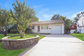 Independence house for rent - a white house with a driveway and a white garage door