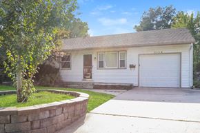 Independence house for rent - a white house with a driveway and a white garage door