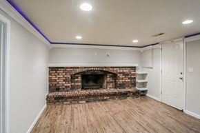 Independence house for rent - a living room with a brick fireplace and a wooden floor