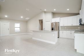 Lehigh Acres house for rent - an empty kitchen with white cabinets and a white counter top