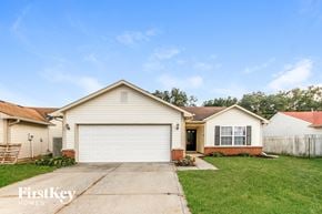 Indianapolis house for rent - a white house with a white garage door and a lawn