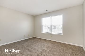Indianapolis house for rent - the living room of an apartment with carpet and a window