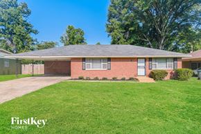 Memphis house for rent - a brick house with a lawn and a driveway