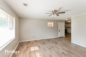 Memphis house for rent - the living room and dining room with wood flooring and a ceiling fan