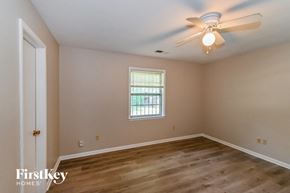 Memphis house for rent - an empty bedroom with a ceiling fan and a window