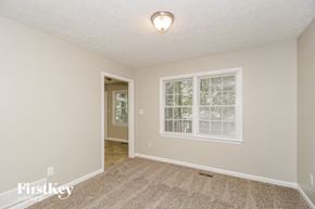 Dallas house for rent - a living room with a large window and a carpeted floor