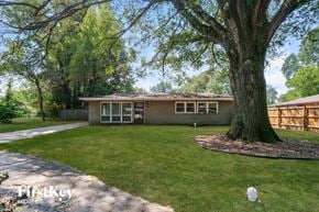 Memphis house for rent - A house with a large tree in front of it.