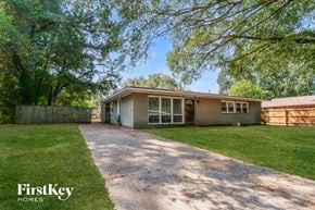 Memphis house for rent - A house with a driveway and trees in the background.