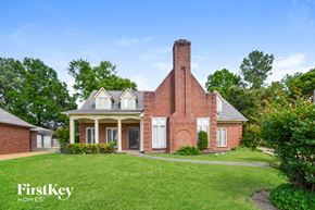 Memphis house for rent - A brick house with a chimney and a porch.