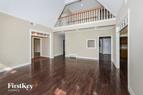 Memphis house for rent - A spacious room with wooden floors and a balcony.