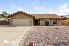 Glendale house for rent - a house with a gravel driveway and a garage door