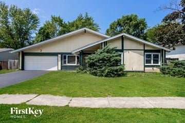 Hanover Park house for rent - a home with a lawn and a sidewalk in front of it