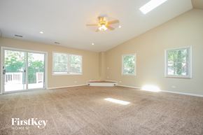Hanover Park house for rent - an empty living room with a ceiling fan