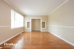 Hanover Park house for rent - an empty living room with wood floors and white walls