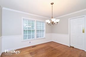 Clemmons house for rent - a dining room with a large window and a chandelier