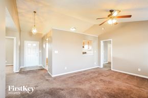 Indianapolis house for rent - A spacious room with a carpeted floor and a ceiling fan.
