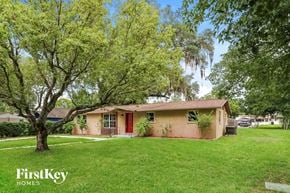 Zephyrhills house for rent - a small pink house with a yard and trees
