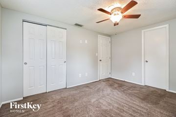 Zephyrhills house for rent - the living room of our studio apartment atrium with carpet and a ceiling fan