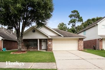 Humble house for rent - a white and brick house with a driveway and a tree