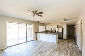 Glendale house for rent - A spacious kitchen with a fan and a view of the outside.