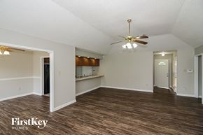 Memphis house for rent - an empty living room with a ceiling fan and a kitchen