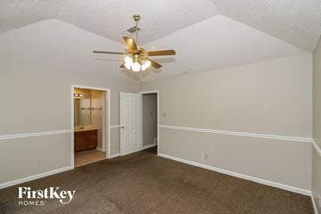Memphis house for rent - a living room with carpet and a ceiling fan